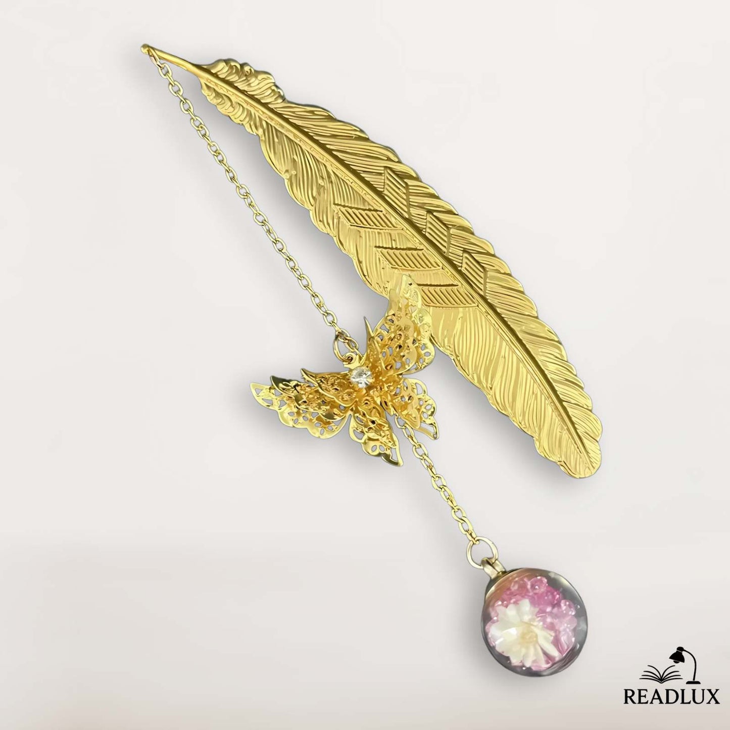 Marque page en métal doré en forme de plume avec pendentif rond et fleurs roses séchées