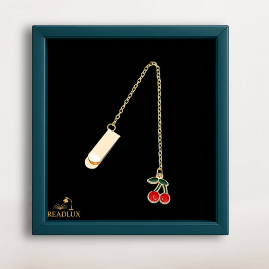 Bijou marque page doré avec pendentif cerise émaillé, élégant et ludique pour roman ou carnet.