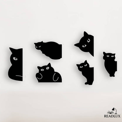 Ensemble de marque pages chats noirs stylisés, silhouettes minimalistes avec yeux blancs, sur fond clair.