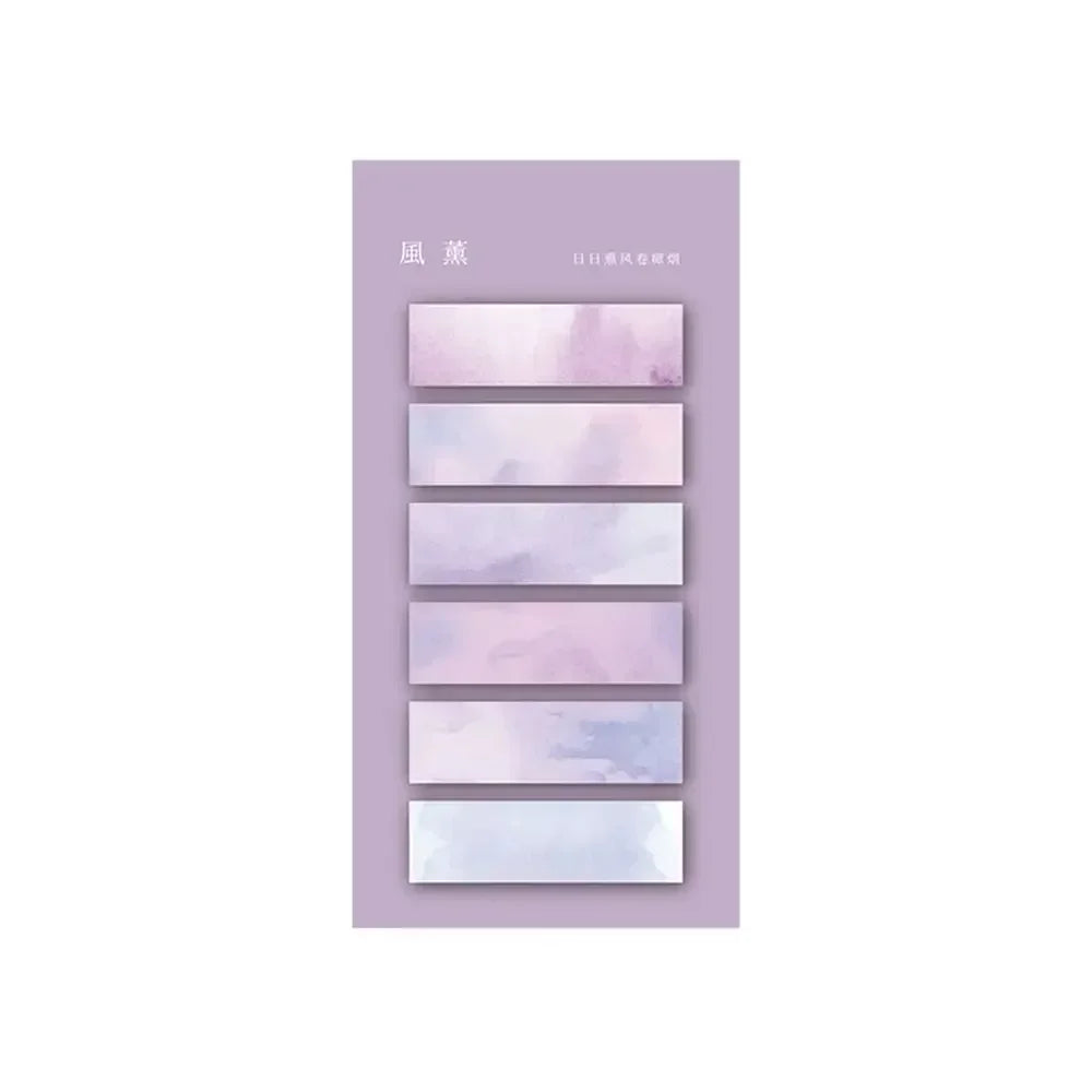 Ensemble de marqueurs autocollants transparents aux teintes pastel de violet et bleu, présentés sur un fond mauve
