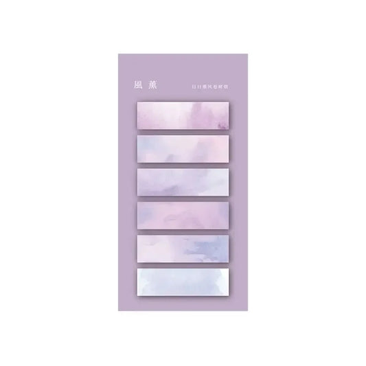 Ensemble de marqueurs autocollants transparents aux teintes pastel de violet et bleu, présentés sur un fond mauve