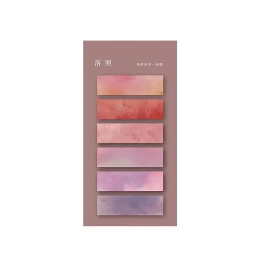 Ensemble de marqueurs autocollants transparents dégradés en rose, violet et rouge, disposés verticalement sur fond beige