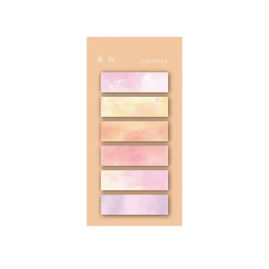Des marqueurs autocollants transparents aux dégradés de rose et jaune, présentés sur un fond beige